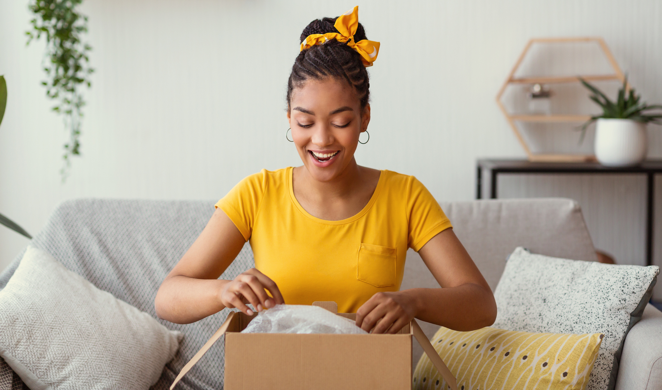A woman opens a box with a gift inside